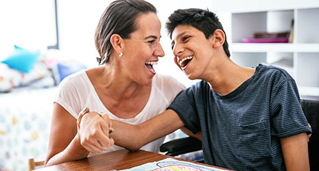 a mother and son smiling and laughing